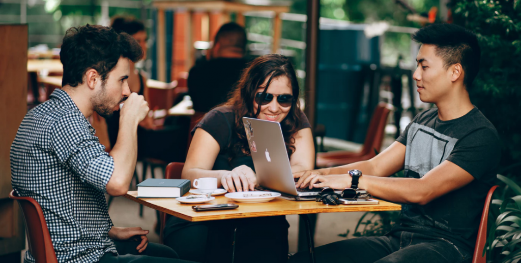 Three people sitting at a cafe