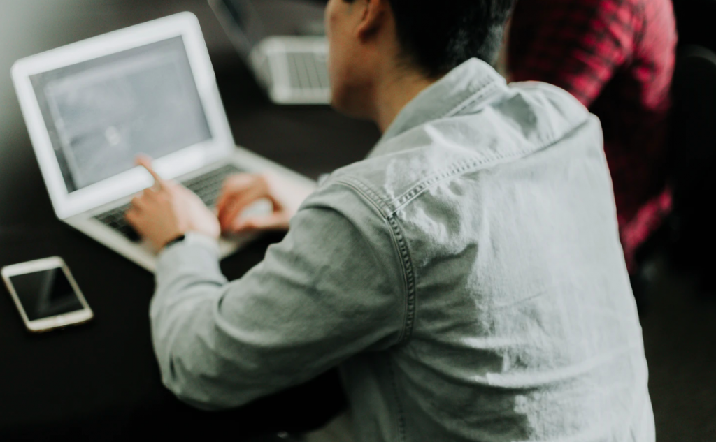 Two guys planning with laptops