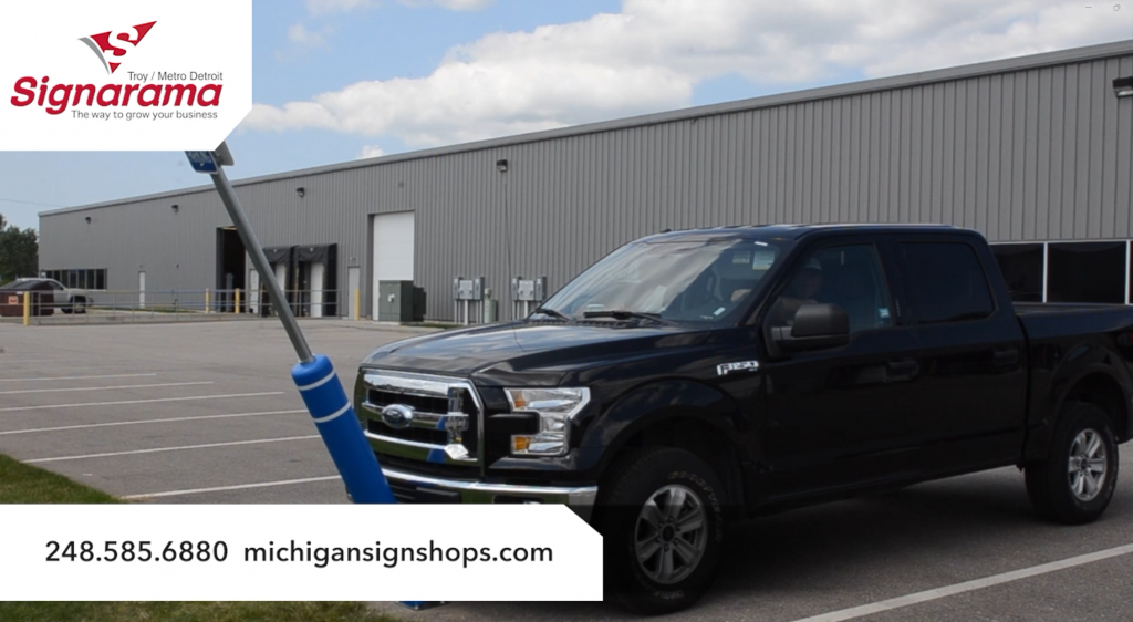 Ford F-150 hitting a flexible parking sign in a parking lot