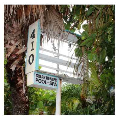 An abandoned hotel sign in disrepair