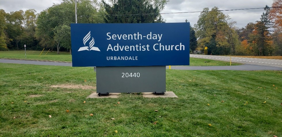 Church sign on grassy lawn
